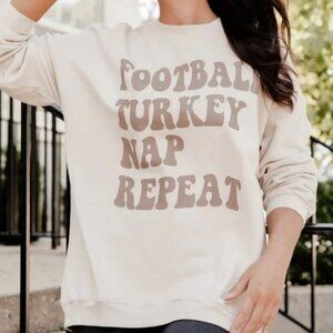 Football turkey nap repeat light tan oversized graphic sweaterFootball turkey na